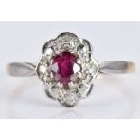 An 18ct gold ring set with a ruby and diamonds in a platinum setting, 1.9g, size K