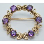 A 9ct gold brooch set with amethysts and butterfly design, diameter 3cm, 5.2g