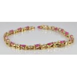 A 10k gold bracelet set with rubies and diamonds, 5.8g