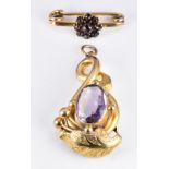 Victorian pendant set with an oval cut amethyst, 1.5 x 3.5cm and a 9ct gold brooch set with Bohemian