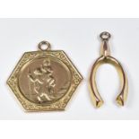 A 9ct gold St Christopher pendant and a 9ct gold wishbone charm/pendant, 2.3g