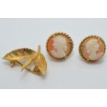 A pair of 9ct gold earrings set with a cameo to each (3.6g) and a yellow metal brooch (1.8g)