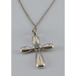 An 18ct white gold cross pendant set with a diamond, 2g