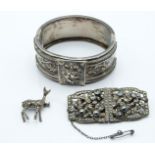 Victorian silver bangle with applied floral decoration, a French white metal metamorphic brooch