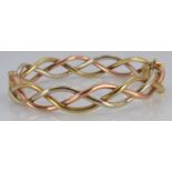 A 9ct gold tri-coloured bangle, 20.2g