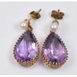 A pair of earrings each set with a pear cut amethyst and a pearl to the stud, 0.5 x 2cm