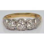 An 18ct gold ring set with three diamonds in a platinum setting, 2.8g, size K