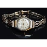 Uno 9ct gold cased ladies wristwatch with gold hands and numerals, silver dial and signed 15 jewel