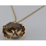 A 9ct gold pendant set with smoky quartz (London 1977) on 9ct gold chain, 12.5g