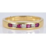 An 18ct gold ring set with alternating rubies and diamonds, 3.8g, size N