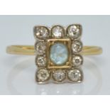 An 18ct gold ring set with an oval cut aquamarine surrounded by diamonds, 2.2g, size L