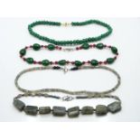 An emerald and jade necklace, two labradorite necklace, and a quartz necklace