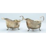 Pair of George VI hallmarked silver sauce boats raised on three feet, Birmingham 1939/40 maker