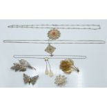 Four silver filigree brooches, two silver filigree pendants and an opalescent necklace