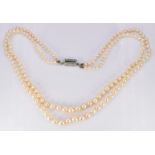 A double strand of cultured pearls, the 18ct gold and platinum clasp set with five square cut