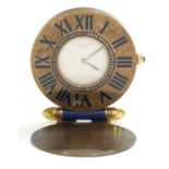 Cartier brass folding travelling clock, the white dial with inlaid blue enamel Roman numerals and