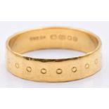 A 22ct gold wedding band/ ring with circular decoration,4.6g, size S
