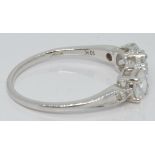 A 10k white gold ring set with three zircons and diamonds, with certificate, size S