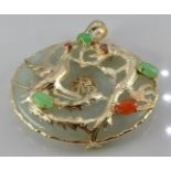A 9ct gold pendant set with jadeite with dragon decoration