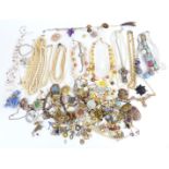 A collection of costume jewellery including vintage brooches, beads, jet brooch, foiled paste