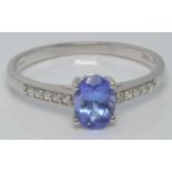 A 10k gold ring set with tanzanite and zircons, with certificate, size U