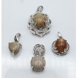 Four silver pendants set with flint stone and diamonds, dinosaur bone and zircon, cat's eye sunstone