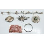 Victorian silver brooch with applied gold decoration, a silver brooch set with glass by Caithness,