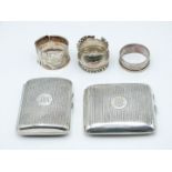 Two hallmarked silver cigarette cases and three hallmarked silver napkin rings, various hallmarks