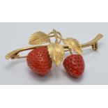 An 18k gold brooch set with two coral drops in the form of a strawberry plant, 2.6 x 4.5cm, 6.6g
