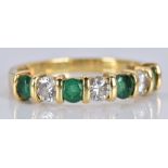 An 18ct gold ring set with alternating emeralds and diamonds, each gemstone approximately 0.15ct,