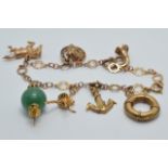 A 9ct gold charm bracelet with seven 9ct gold charms including a horse shoe and horse, anchor,
