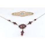 A silver necklace set with bohemian cut garnets, length 45cm, and a yellow metal pierced brooch, 1 x