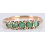 A 9ct gold ring set with emeralds, 1.8g, size M
