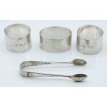 Three hallmarked silver napkin rings including a pair, one Edinburgh 1943 and a pair of hallmarked