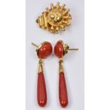 A pair of 18ct gold earrings each set with a coral cabochon and a further tear shaped coral bead,