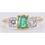An 18ct gold ring set with an emerald cut emerald and two diamonds, each approximately 0.2ct, 3.