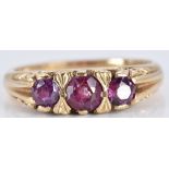 A 9ct gold ring set with three round cut garnets, 3.1g, size M