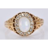 A late Victorian ring set with an oval opal cabochon surrounded by rose cut diamonds, 5.5g, size O/