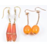 A pair of Art Deco 9ct gold earrings set with amber drops and a similar pair