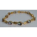 A 9ct gold tennis bracelet set with mystic topaz