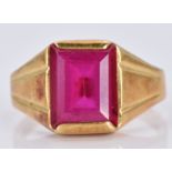 An 18ct gold ring set with an emerald cut synthetic ruby, 5.5g, size P