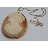 A 9ct gold brooch set with a cameo with an unusual guard chain, 3 x 4cm