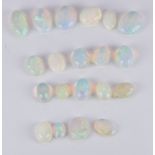 Twenty loose oval opal cabochons