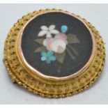 A c1900 Victorian yellow metal brooch set with a pietra dura plaque, diameter 2.4cm