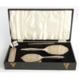 Broadway & Co hallmarked silver mounted dressing table set comprising hand mirror, two brushes and