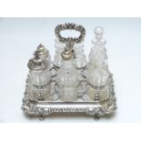 Silver plated seven bottle cruet with ornate cast decoration, width 25cm, depth 19cm, height 27cm