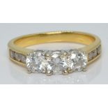 An 18ct gold ring set with three diamonds of approximately 0.3ct, 0.25ct and 0.25ct and further
