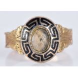 Victorian yellow metal mourning ring with black enamel decoration and hair set to the centre, 2.