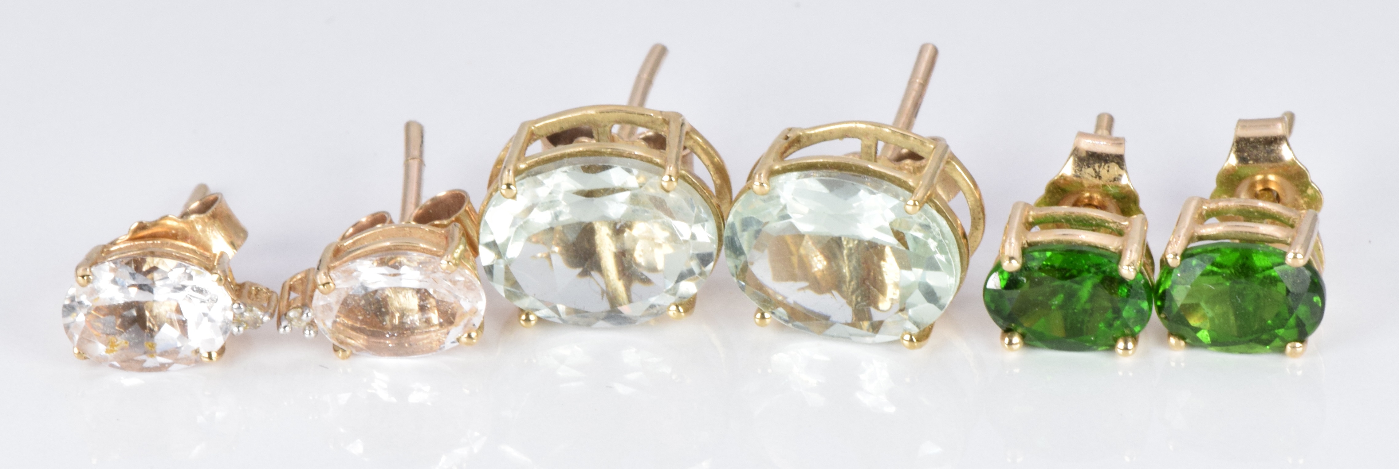 Three pairs of 9ct gold earrings set with aquamarine, tourmaline and zircons