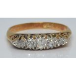 An 18ct gold ring set with five old cut diamonds, 3.0g, size L